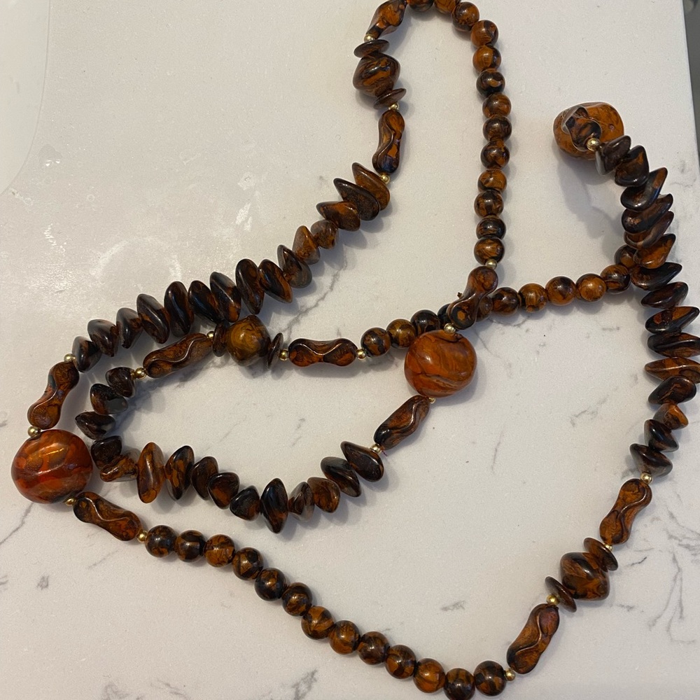 Tortoise shell colored beaded necklace.